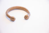 Antique African cuff bracelet highlighting the open shape and hand-worked faceted ends.