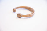 Antique African cuff bracelet's squared terminal showing hand-worked character and patina.
