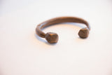 Hand-carved markings on the geometric end of the antique bronze cuff bracelet.