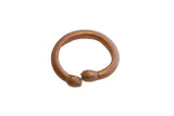 Antique African snake cuff bracelet with a warm, oxidized metal patina.