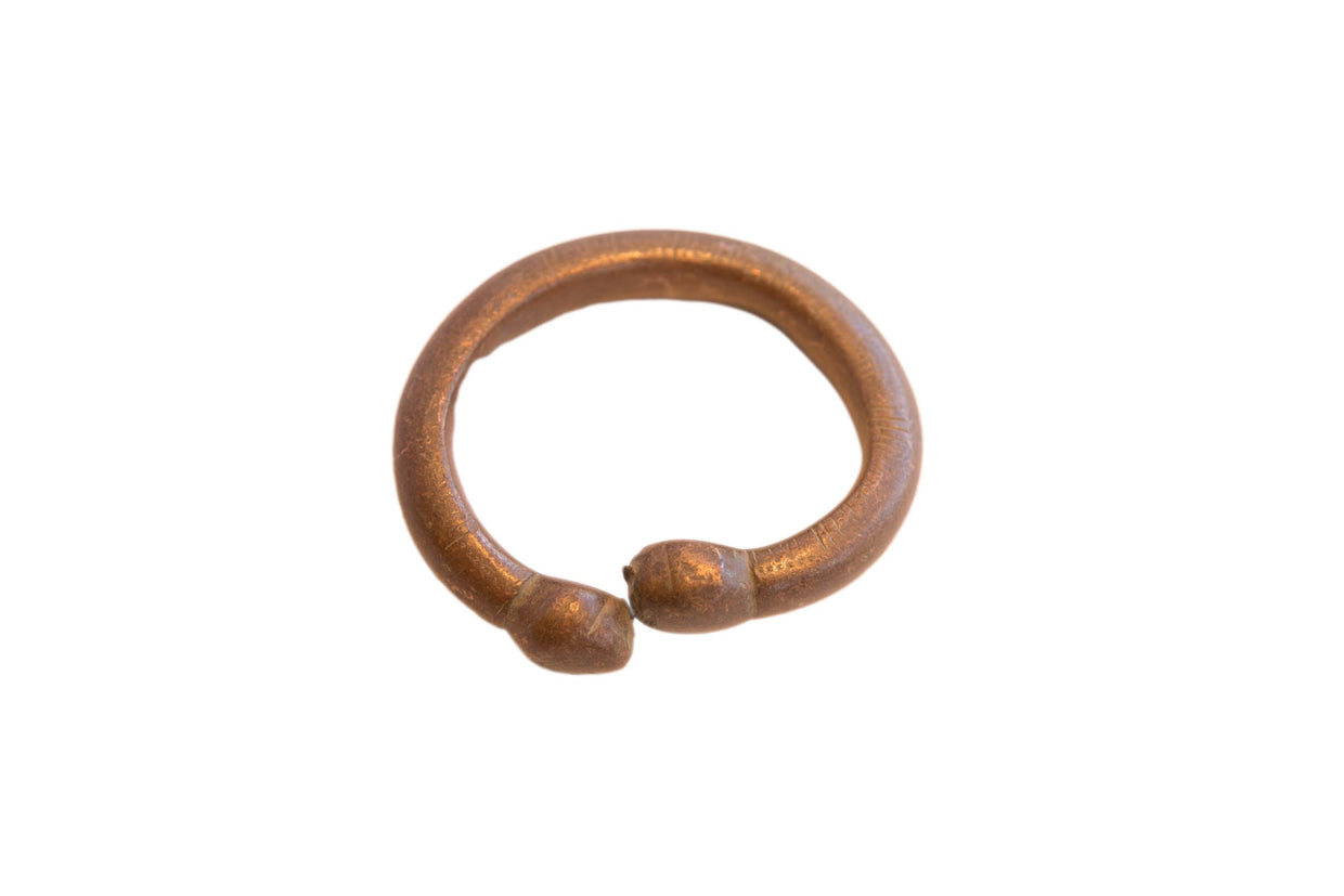Antique African snake cuff bracelet with a warm, oxidized metal patina.