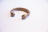 Hand-etched details on the faceted snake head of an antique African cuff bracelet.