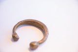 Side profile of the antique African snake cuff showing its open form and aged patina.