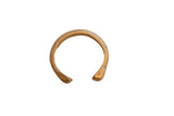 Antique African snake cuff bracelet with a time-softened golden patina and etched details.