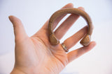 Antique African copper cuff bracelet held in palm, showing its shape and scale.