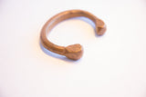 Hand-forged texture and stamped markings on a faceted end of the antique African cuff.
