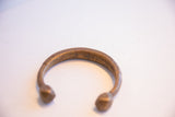 Incised patterns and aged patina detail on an antique handmade African cuff bracelet.