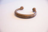 Angled view of the collectible African cuff bracelet showing its open form and rich patina.
