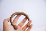 Hand-etched linear patterns and aged patina on the surface of the antique snake cuff.