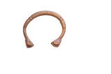 Antique African snake cuff bracelet with stylized ends and a warm, aged metal patina.