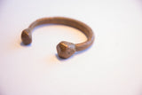 The textured band and faceted terminal of the antique African snake cuff.
