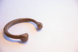 Antique African cuff bracelet showing its distinctive open form and faceted ends.