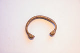 Antique African copper snake cuff bracelet showing its hand-forged shape and warm, aged patina.