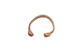 Antique African snake cuff bracelet with a handmade texture and warm, aged patina.