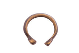 Antique African snake cuff bracelet with a dark, textured and oxidized finish.
