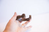 The hand-carved end and opening of the antique African snake cuff bracelet.