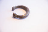 Side view of the antique African snake cuff bracelet showing its open form and textured surface.