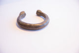 Side view of the antique African snake cuff bracelet showing its open design.