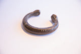 Angled view showing the dark, aged patina on the handmade African snake cuff bracelet.