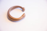 Angled view of the antique copper snake cuff showing its open form and warm patina.