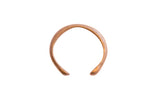 Antique African handmade copper cuff bracelet with a smooth, open design and aged patina.