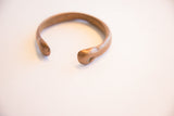 Detail of the antique African copper cuff showing its rounded, hand-formed ends.