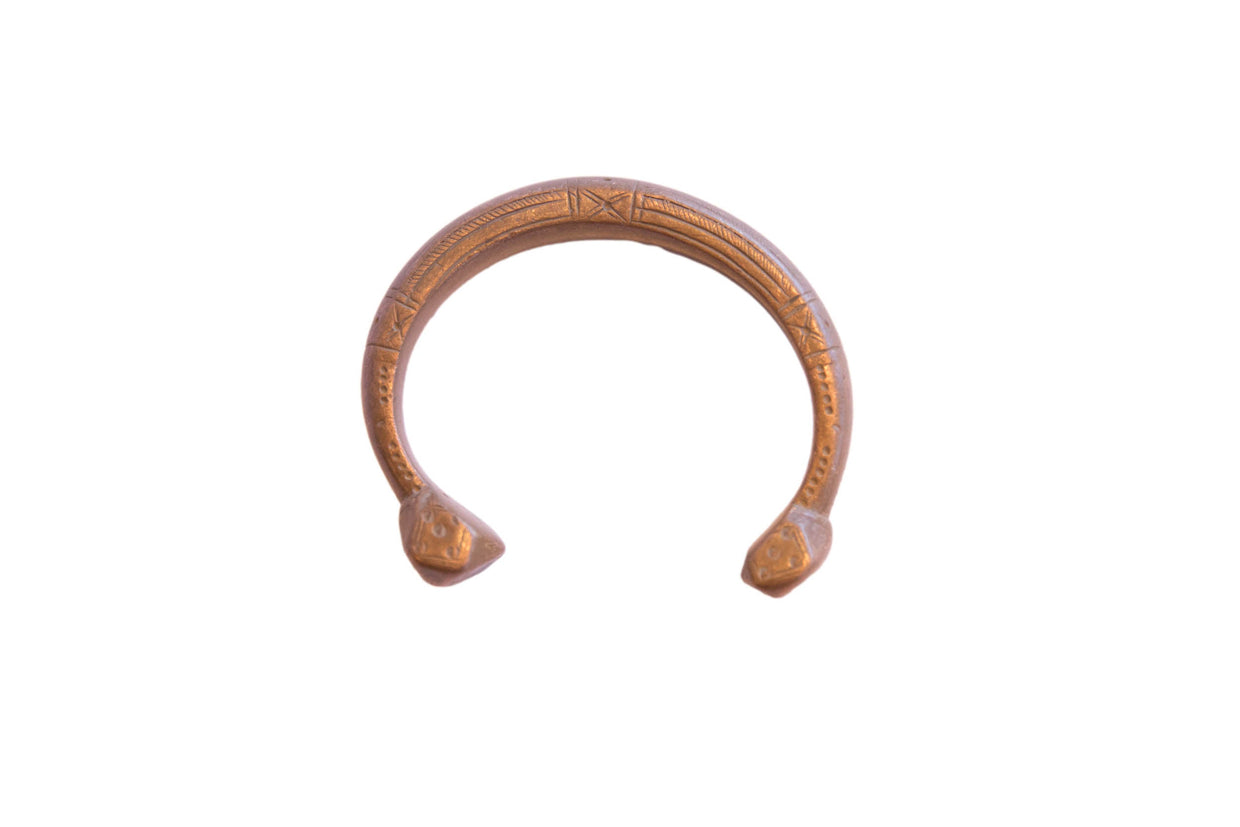 Antique African copper snake cuff bracelet with etched details and a warm, aged patina.