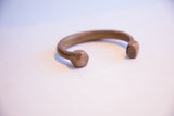 Antique copper snake cuff showing the opening and faceted geometric ends.
