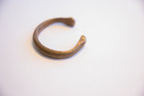 Side profile of the antique African bracelet showing its open cuff design.