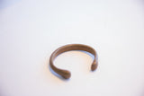 Profile view of the antique African cuff showing the open shape and smooth finish.