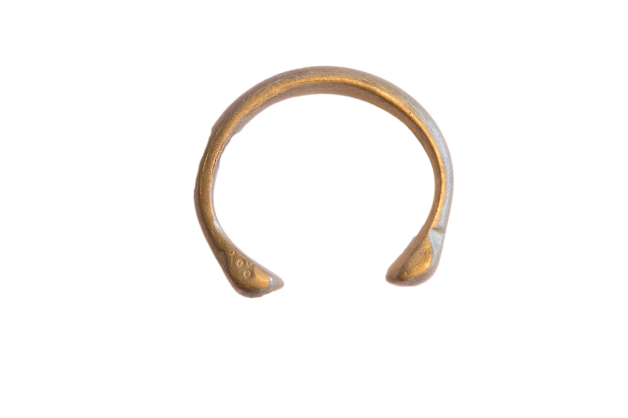 Antique African bronze snake cuff bracelet with a rustic, handmade texture and aged patina.