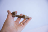 Antique African bronze bracelet held in palm, showing scale and handcrafted form.