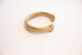 Side profile of the antique African bronze cuff showing its substantial form and open design.