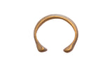 Antique African bronze snake cuff bracelet with a circular form and aged patina.