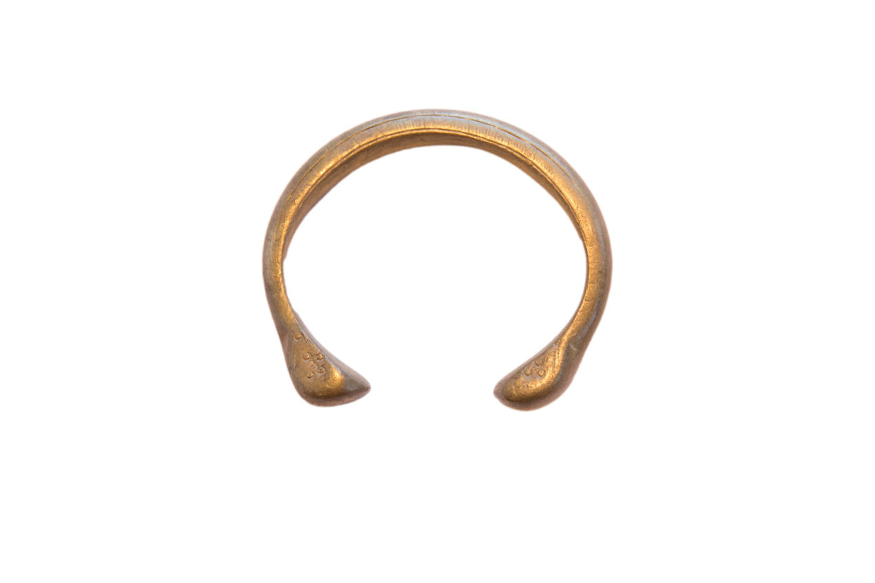Antique African bronze snake cuff bracelet with a circular form and aged patina.