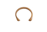 An antique African bronze snake cuff bracelet with stylized heads and an etched band.