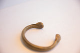 Close-up of the handcrafted snake head terminal on the antique bronze cuff.