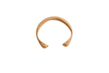 Antique African snake cuff bracelet with hand-stamped details and a warm brass patina.