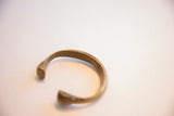 Side view of the collectible African snake cuff showing its warm, aged patina.