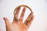 Stamped circular details along the inner curve of the antique snake cuff.