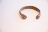 Antique African cuff bracelet showing its open form and smooth rounded ends.