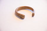 Close view of the hand-worked details on an antique African snake cuff's open end.