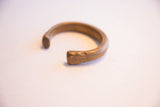 Hand-worked texture and aged patina on the open end of the snake cuff.