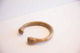 Angled view of the antique snake cuff showing its open shape and aged metal finish.
