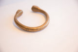 Antique African cuff bracelet showing its simple, open form and aged patina.