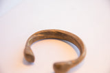 Detail view of the antique snake cuff's textured surface and aged metal patina.