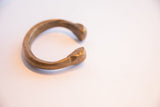 Side view of the antique African snake cuff showing its open shape and aged bronze finish.