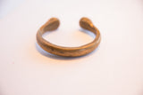 Profile of the antique African cuff, highlighting its solid, curved shape and aged metal patina.