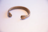 View of the antique snake cuff's open design and smooth, hand-formed terminal.
