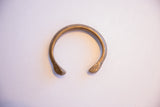 Antique African snake cuff bracelet laid flat showing its full open form.